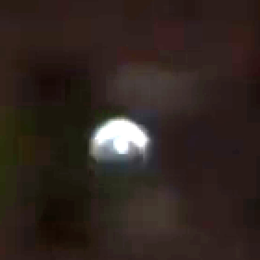 9x zoomed, brightness-boosted crop of the claimed hard-line frame, showing the light source as a soft, blurred blob rather than a sharply-defined edge.